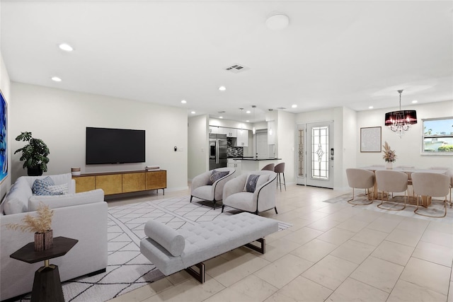 living area with recessed lighting, a notable chandelier, visible vents, and plenty of natural light