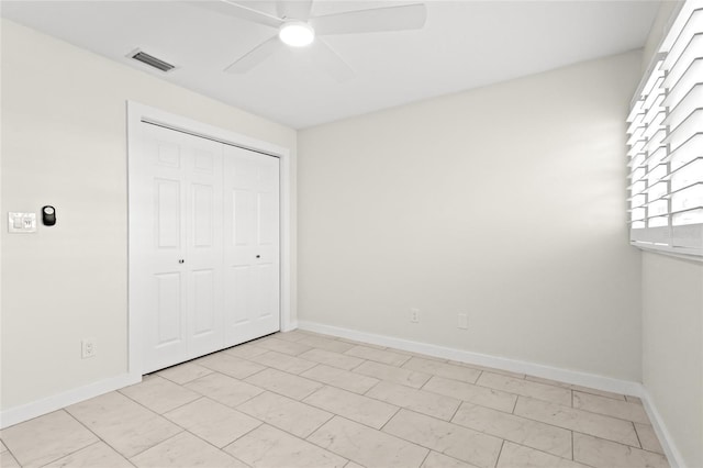 unfurnished bedroom with baseboards, a closet, visible vents, and a ceiling fan