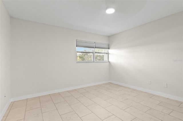 spare room with baseboards