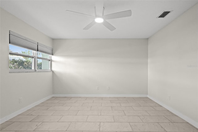 spare room featuring visible vents, baseboards, and a ceiling fan