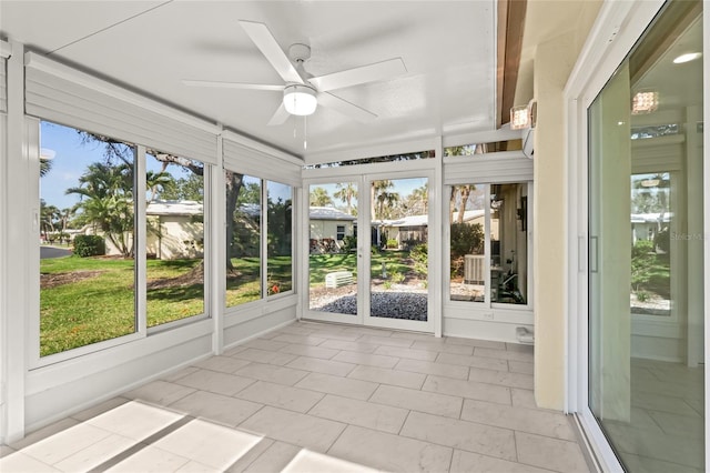 unfurnished sunroom with a ceiling fan