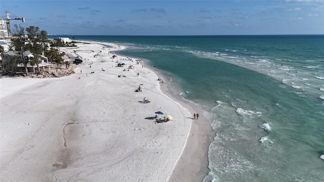 bird's eye view featuring a water view and a beach view