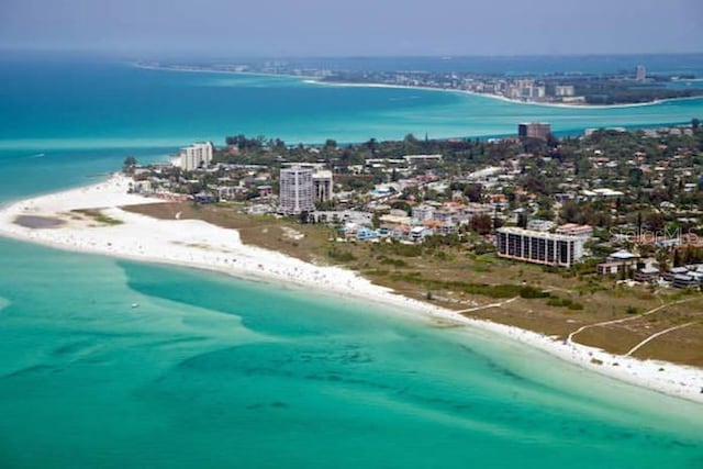 aerial view featuring a beach view, a water view, and a city view
