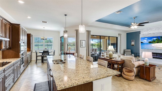 20359 Cristoforo Pl, Venice, FL 34293 - kitchen featuring a sink, healthy amount of natural light, an island with sink, stainless steel appliances, and ornamental molding