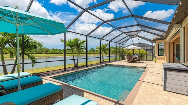 20359 Cristoforo Pl, Venice, FL 34293 - swimming pool featuring a patio area, a water view, glass enclosure, and outdoor dining space