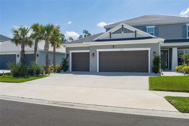 view of front of property with an attached garage, stucco siding, and driveway