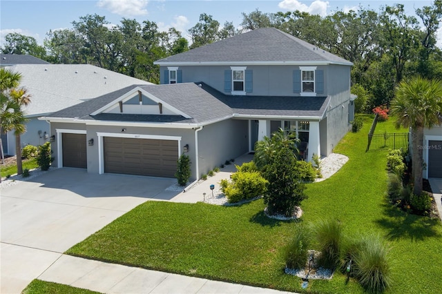 traditional home with an attached garage, concrete driveway, stucco siding, and a front lawn