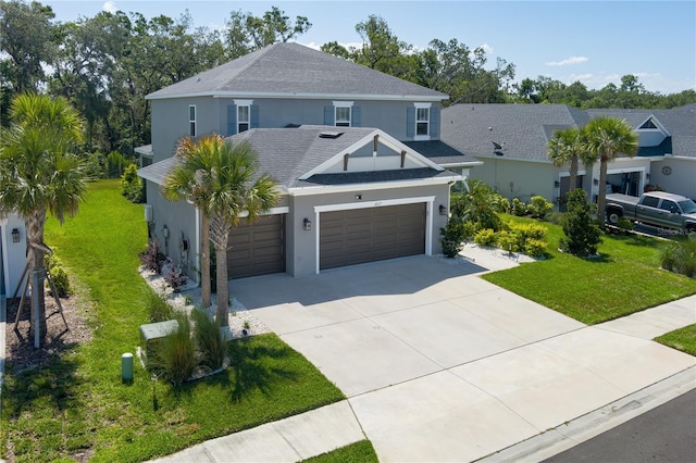 traditional home featuring concrete driveway, an attached garage, stucco siding, and a front lawn