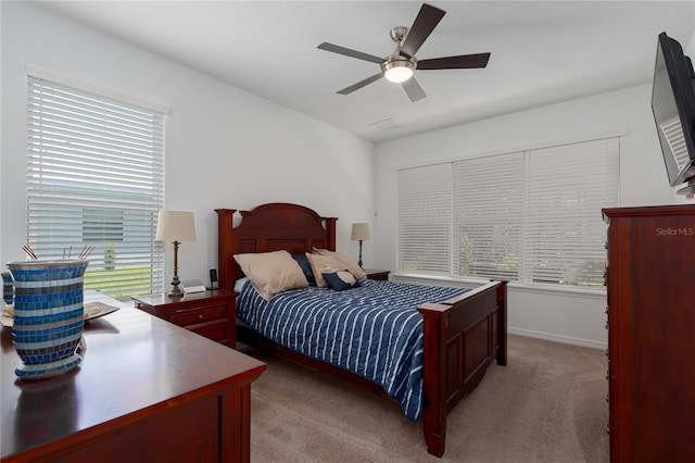 bedroom with light colored carpet, baseboards, and ceiling fan