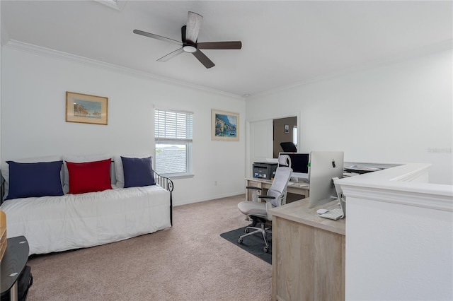 carpeted home office featuring crown molding, baseboards, and ceiling fan