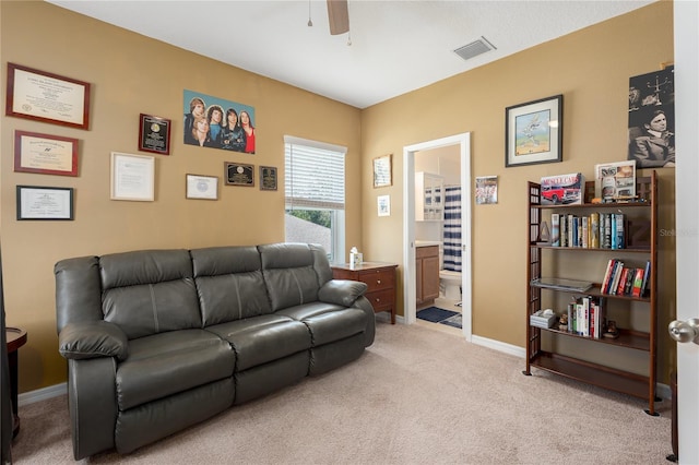 living room with a ceiling fan, baseboards, visible vents, and light colored carpet