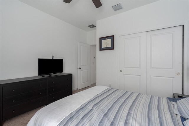 bedroom featuring carpet floors, a closet, a ceiling fan, and visible vents