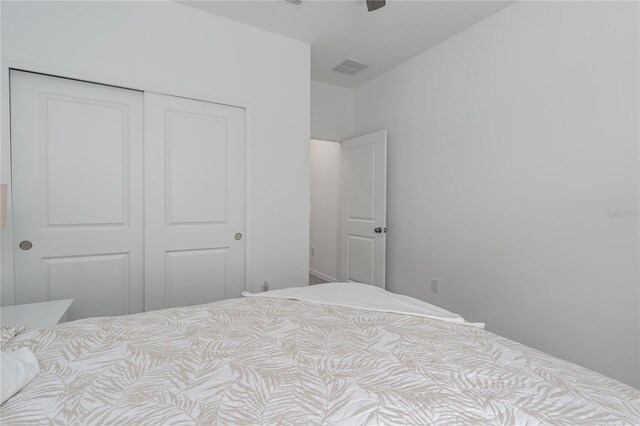 bedroom featuring ceiling fan, a closet, and visible vents