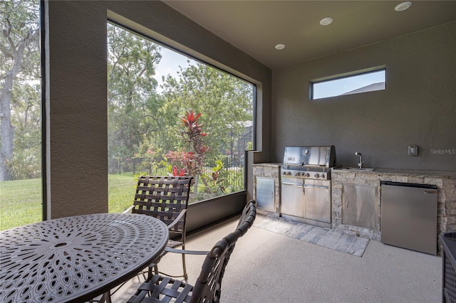 sunroom / solarium featuring a sink