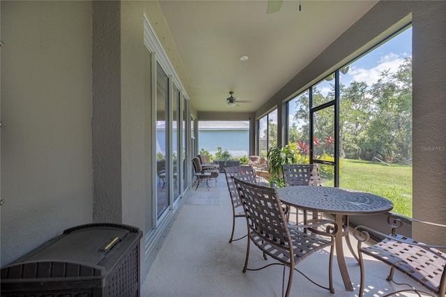 sunroom with ceiling fan and outdoor dining space