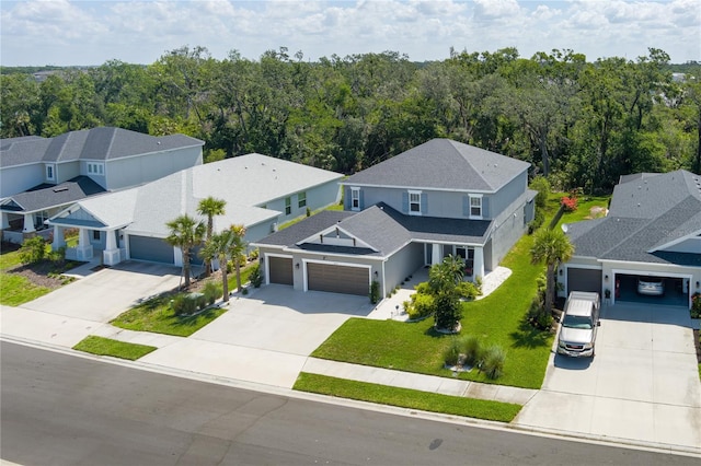 bird's eye view with a wooded view and a residential view