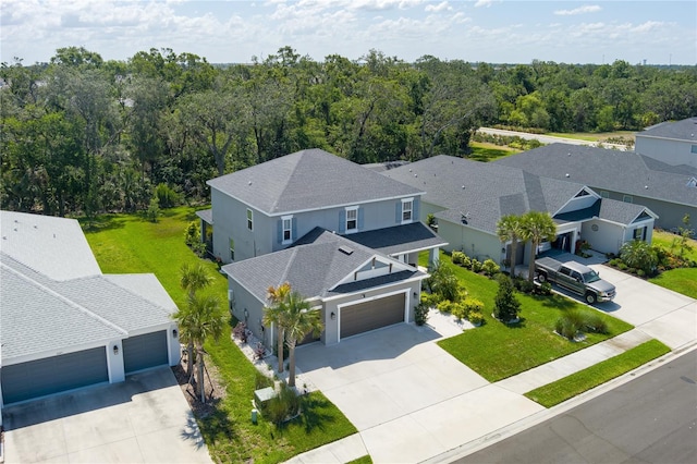 birds eye view of property with a wooded view and a residential view