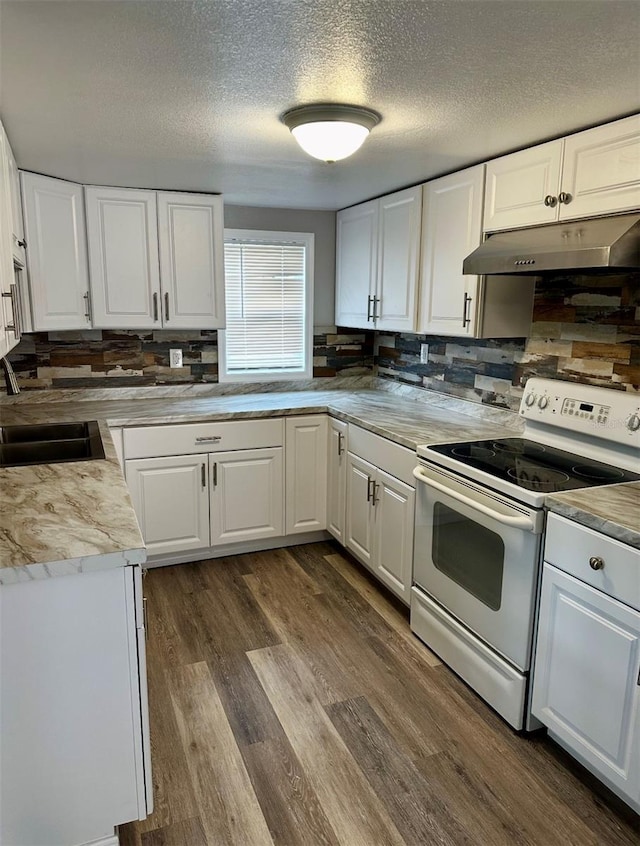 kitchen with a sink, a textured ceiling, under cabinet range hood, white cabinets, and white range with electric stovetop