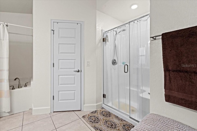 4466 Manila Ave, North Port, FL 34288 - bathroom featuring a shower stall, tile patterned flooring, a bath, and baseboards