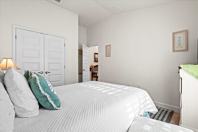 4466 Manila Ave, North Port, FL 34288 - carpeted bedroom with a closet, vaulted ceiling, and baseboards