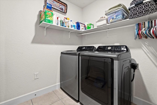 4466 Manila Ave, North Port, FL 34288 - laundry room featuring washer and dryer, light tile patterned flooring, and baseboards