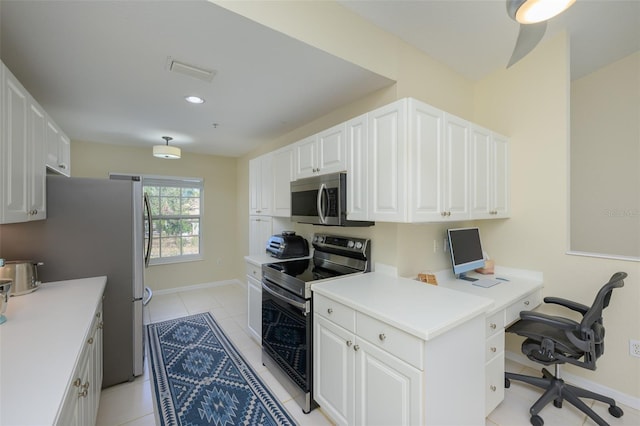 6748 Fairview Ter Unit 4-202, Bradenton, FL 34203 - kitchen featuring stainless steel appliances, white cabinets, a desk, light tile patterned flooring, and light countertops