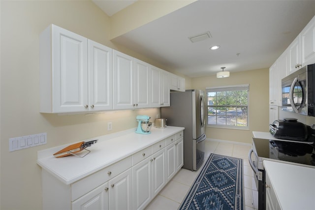6748 Fairview Ter Unit 4-202, Bradenton, FL 34203 - kitchen with stainless steel appliances, white cabinets, light tile patterned floors, light countertops, and recessed lighting