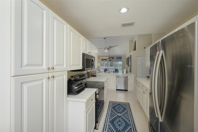 6748 Fairview Ter Unit 4-202, Bradenton, FL 34203 - kitchen with appliances with stainless steel finishes, light tile patterned floors, white cabinets, light countertops, and a ceiling fan