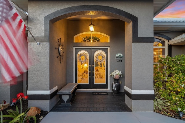 490 Pine Lily Way, Venice, FL 34293 - doorway to property featuring stucco siding and french doors