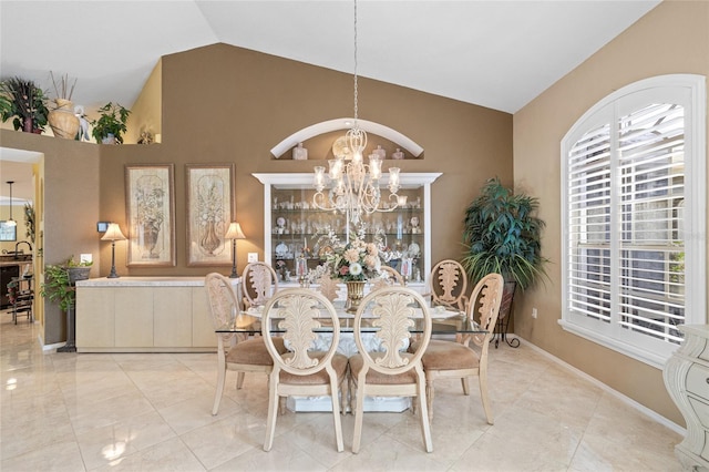 490 Pine Lily Way, Venice, FL 34293 - dining area featuring a chandelier, high vaulted ceiling, and baseboards