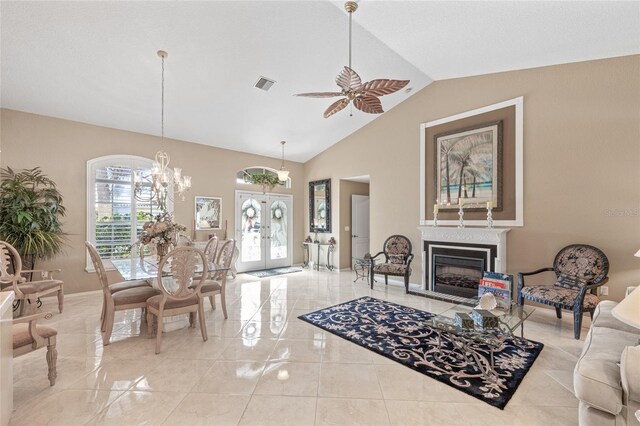 490 Pine Lily Way, Venice, FL 34293 - living room with french doors, a ceiling fan, lofted ceiling, a glass covered fireplace, and a chandelier