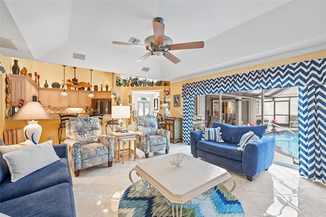 490 Pine Lily Way, Venice, FL 34293 - living area with a ceiling fan, a tray ceiling, light tile patterned floors, and vaulted ceiling