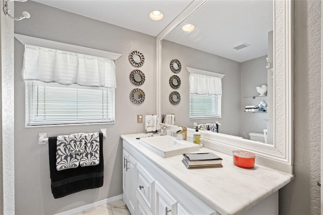 490 Pine Lily Way, Venice, FL 34293 - bathroom with vanity, marble look tiles, toilet, and recessed lighting