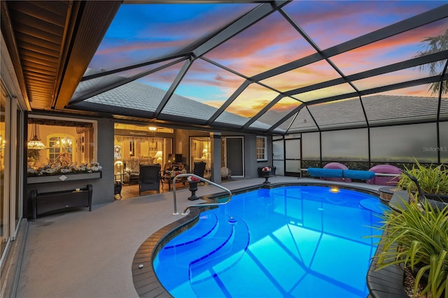 490 Pine Lily Way, Venice, FL 34293 - pool at dusk featuring a patio area, an outdoor pool, and glass enclosure