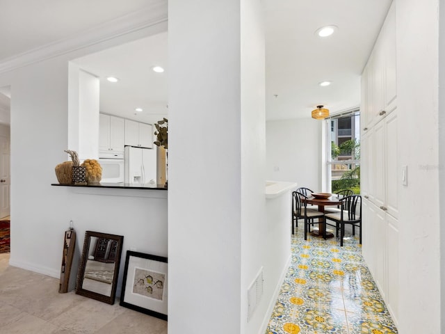 hall with recessed lighting, baseboards, and ornamental molding