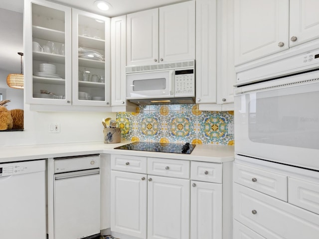 kitchen featuring white appliances, white cabinets, light countertops, and backsplash