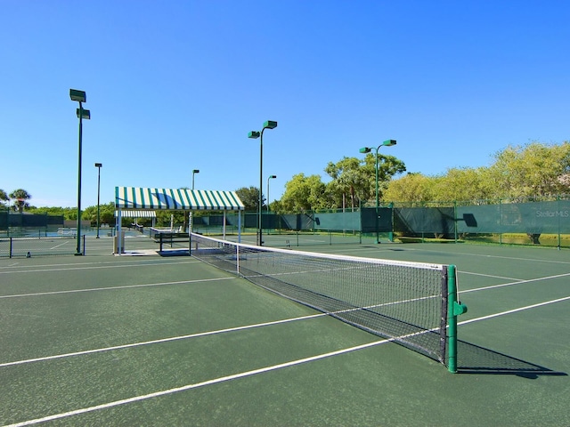 view of tennis court featuring fence