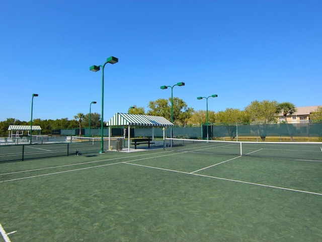 view of tennis court featuring fence