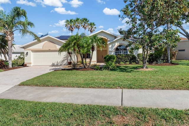 4063 Westbourne Cir, Sarasota, FL 34238 - ranch-style home featuring solar panels, a garage, stucco siding, a front lawn, and concrete driveway