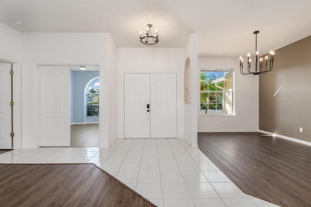 4063 Westbourne Cir, Sarasota, FL 34238 - entryway with a chandelier, light wood-type flooring, and baseboards