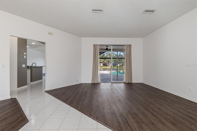 4063 Westbourne Cir, Sarasota, FL 34238 - unfurnished room with baseboards, tile patterned flooring, and a textured ceiling