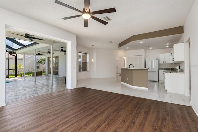 4063 Westbourne Cir, Sarasota, FL 34238 - unfurnished living room featuring light wood-style floors, ceiling fan, and recessed lighting