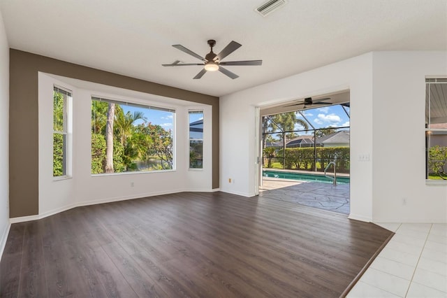 4063 Westbourne Cir, Sarasota, FL 34238 - empty room featuring a ceiling fan, wood finished floors, and baseboards
