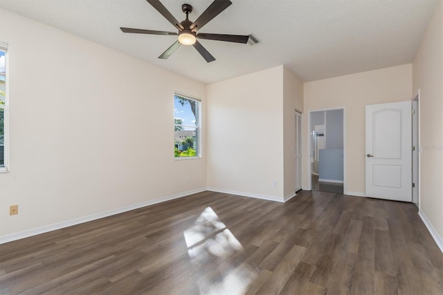 4063 Westbourne Cir, Sarasota, FL 34238 - unfurnished bedroom with wood finished floors, baseboards, a ceiling fan, a closet, and a textured ceiling