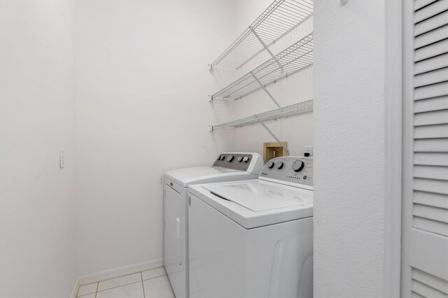 4063 Westbourne Cir, Sarasota, FL 34238 - clothes washing area featuring separate washer and dryer and light tile patterned flooring