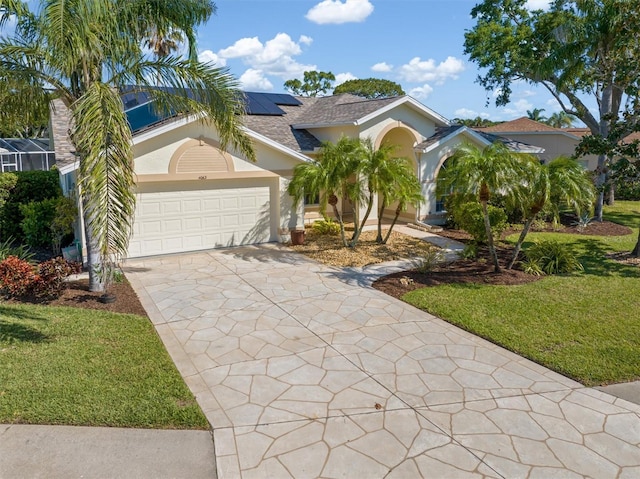4063 Westbourne Cir, Sarasota, FL 34238 - view of front of property with stucco siding, concrete driveway, solar panels, and a garage