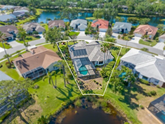 4063 Westbourne Cir, Sarasota, FL 34238 - aerial view of residential area with property parcel outlined, a pool, and a large body of water