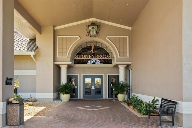 4063 Westbourne Cir, Sarasota, FL 34238 - view of exterior entry featuring french doors and stucco siding