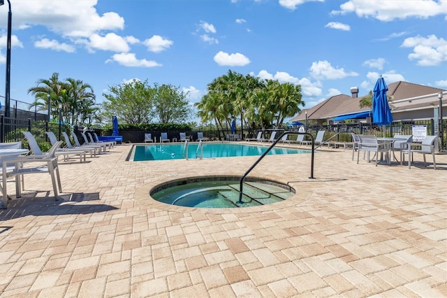 4063 Westbourne Cir, Sarasota, FL 34238 - community pool featuring fence, a patio, and a hot tub