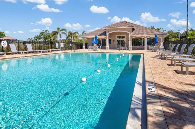 4063 Westbourne Cir, Sarasota, FL 34238 - community pool with fence and a patio area